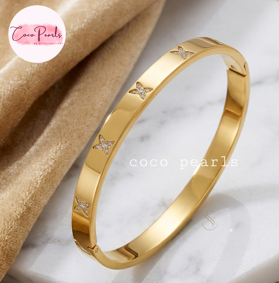 Coco pearls stainless Steel anti tarnish gold flutter handcuff dimaond studded displayed on simple background