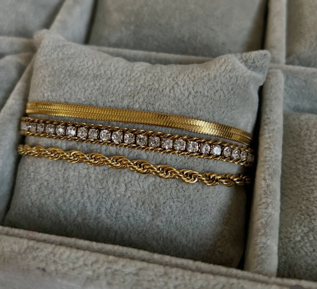 Coco Peals Stainless Steel anti tarnish Three gold bracelets snake chain, diamond accents and twisted rope chain bracelet combo displayed on a textured gray surface