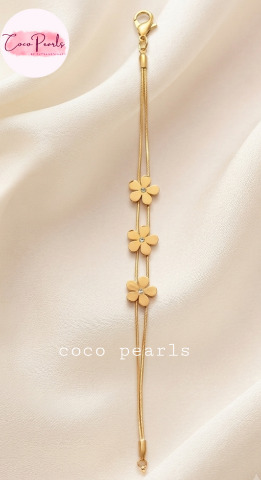 Coco pearls stainless Steel anti tarnish gold triple flower double chain bracelet displayed on simple background