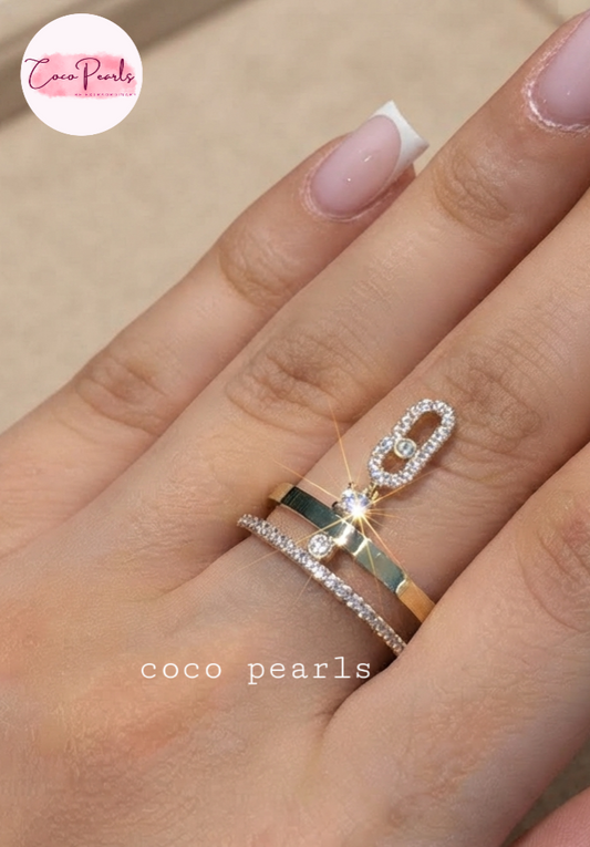 Coco pearls stainless Steel anti tarnish close-up of a hand wearin rings from Coco Pearls. Two layer ring one stone studded one plain. With a stone studded hanging
