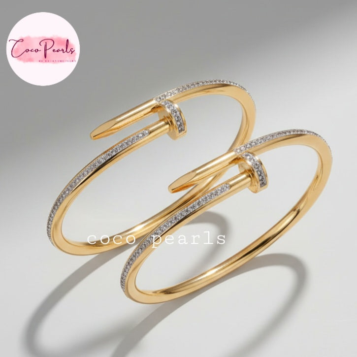 Coco Pearls Stainless Steel Anti Tarnish Gold Aurora nail handcuff diamonds accents on nail design handcuff on a light gray background