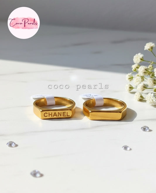 Coco Pearls Stainless Steel Anti Tarnish Gold aurum link ring with Chanel written on a marble surface