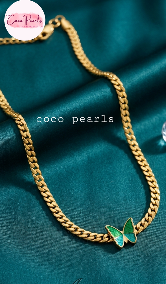 coco pearls stainless steel anti tarnish Gold chain necklace with a green butterfly pendant on fabric