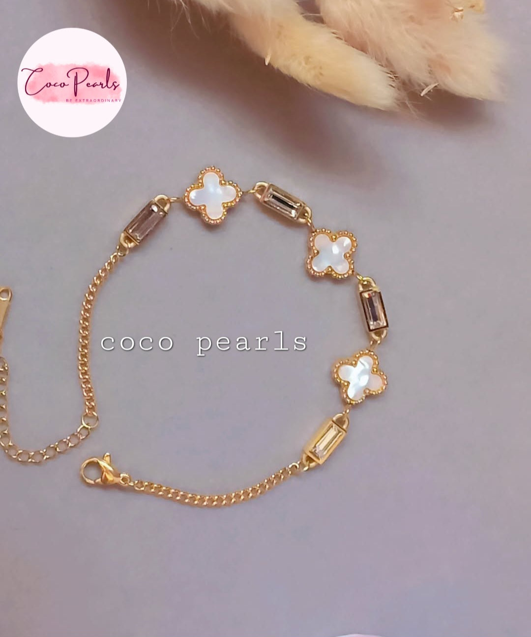 Coco Pearls Stainless Steel Anti Tarnish Gold clover tube bracelet with clover and stones on a soft background