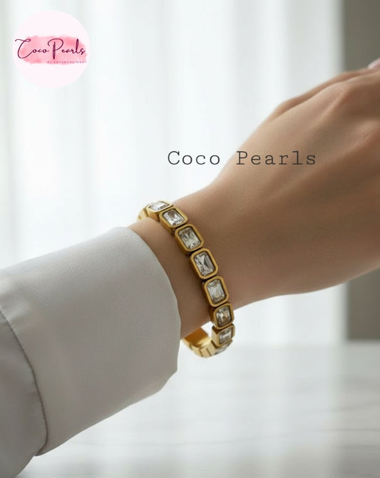 Coco Pearls Stainless Steel Anti Tarnish Gold crystal glam handcuff bangle bracelet with clear rectangular stones on a wrist