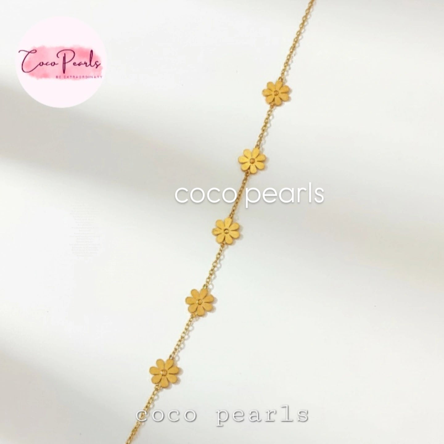 Coco Pearls Stainless steel anti tarnish Gold necklace with yellow flower pendants on a white background.