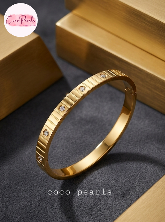 coco pearls stainless steel anti tarnish golden diamond striped handcuff. diamond studded and striped