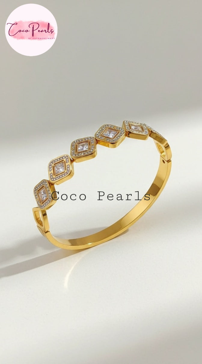 Coco Pearls Stainless Steel Anti Tarnish Gold diamond accent handcuff bangle bracelet with diamond-like stones on a white background