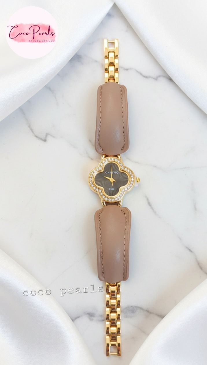 coco pearls Gold and brown watch with a marble background
