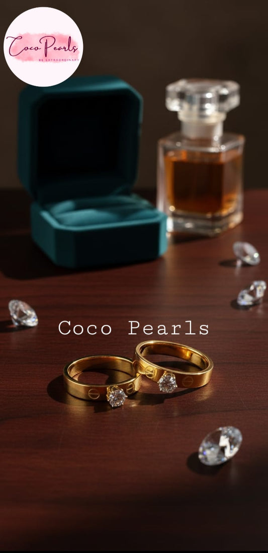 Coco Pearls Stainless Steel Anti Tarnish Gold eternal sparkle rings with diamonds on top, on a wooden surface