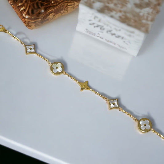 Coco Pearls stainless steel Anti tarnish gold floral cosmos bracelet displayed on simple background