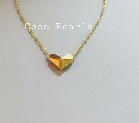 Coco Pearls Stainless Steel Anti Tarnish Gold heart delight necklace with a geometric heart pendant on a light gray background