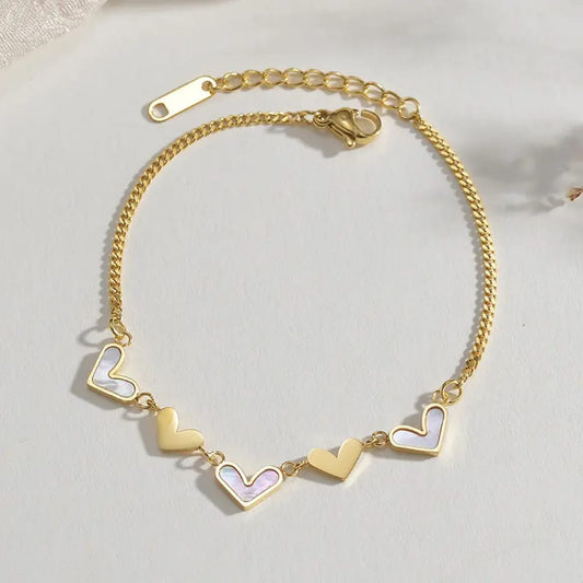 Coco Peals Stainless Steel anti tarnish Gold heart beat charm bracelet with heart-shaped charms on a light background