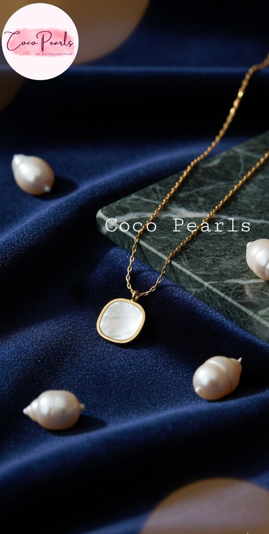 Coco Pearls Stainless Steel Anti Tarnish luminous drop necklace with white square pendant on a dark fabric background