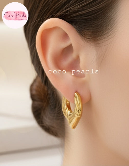Coco Pearls Stainless steel Anti tarnish Gold petal drop hoop earrings worn by a person