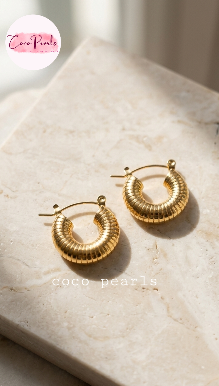 coco pearls stainless steel anti tarnish golden ribbed hoops displayed on a marble surface