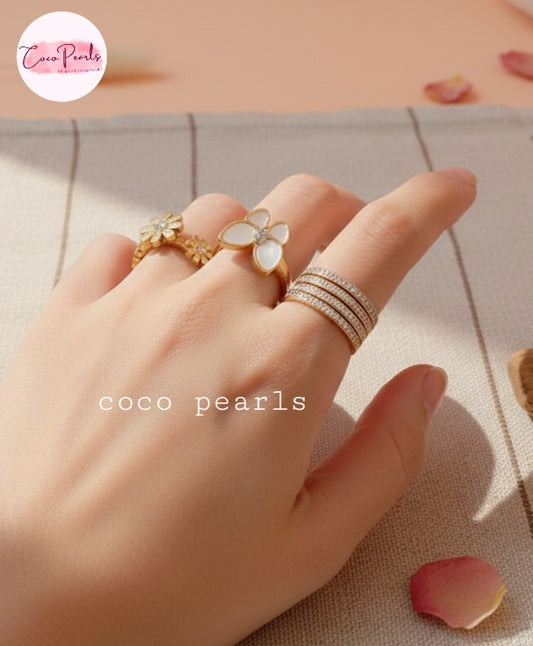 Coco Pearl stainless steel Anti tarnish Hand wearing multiple rings on a soft background
