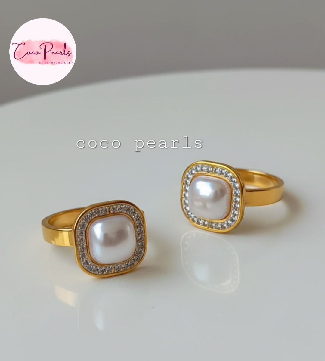 Coco Pearls Stainless Steel Anti Tarnish Gold royal pearl rings with diamond studded square shaped pearl displayed on a marble surface