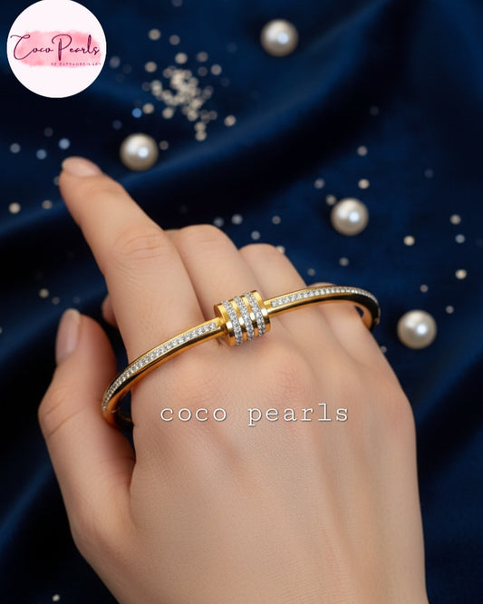 coco pearls stainless steel anti tarnish gold shimmering crown diamond studded handcuff displayed on hand