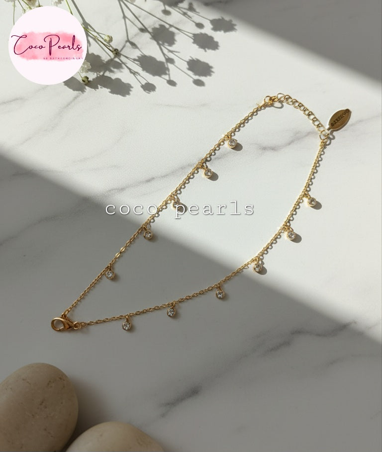 Coco Pearls Stainless steel anti tarnish Gold stardust dots bracelet with small diamonds displayed on a marble surface