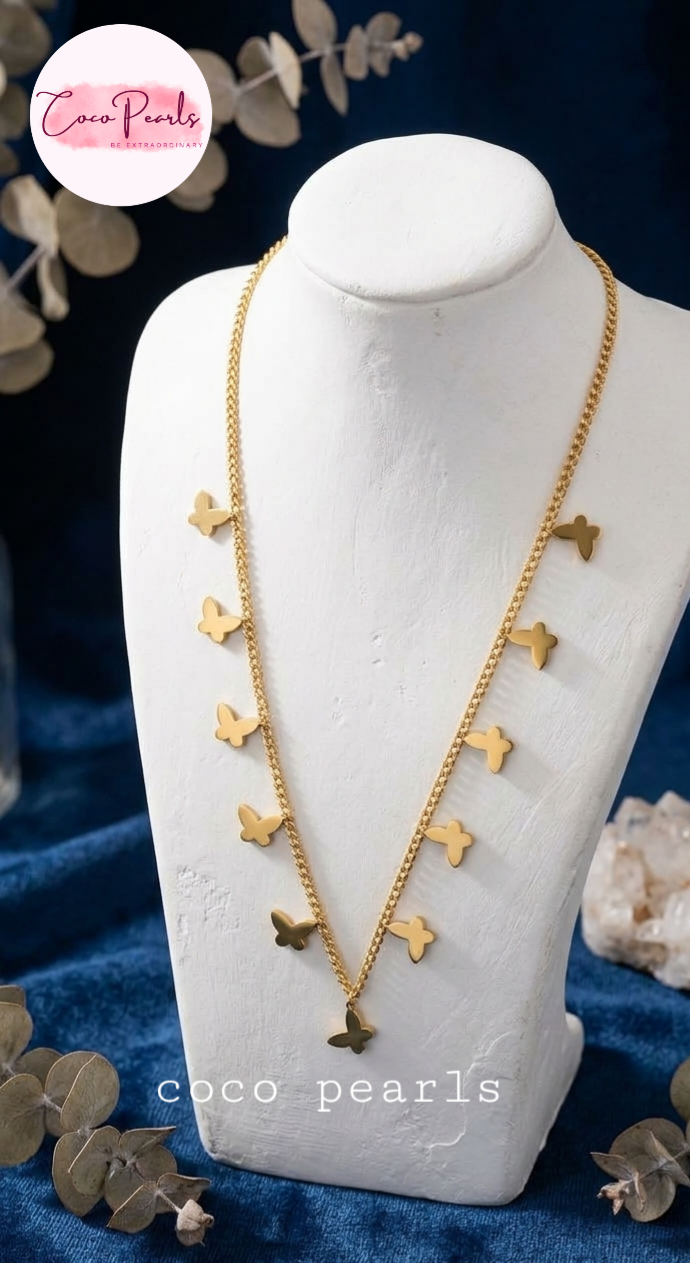 coco pearls stainless steel anti tarnish waterproof gold tiny flutters necklace with tiny butterfly charms all over displayed on a mannequin