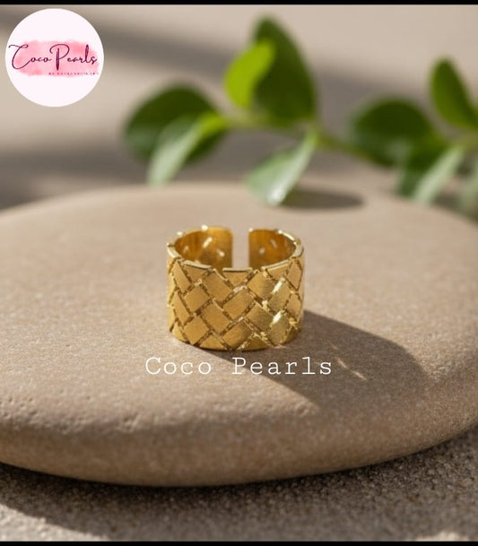 coco pearls stainless steel anti tarnish gold gold woven glow adjustable ring with displayed on a simple background