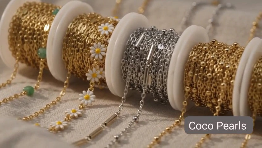 Coco pearls stainless Steel anti tarnish gold  daisy chain with white flowers and yellow center displayed on hand