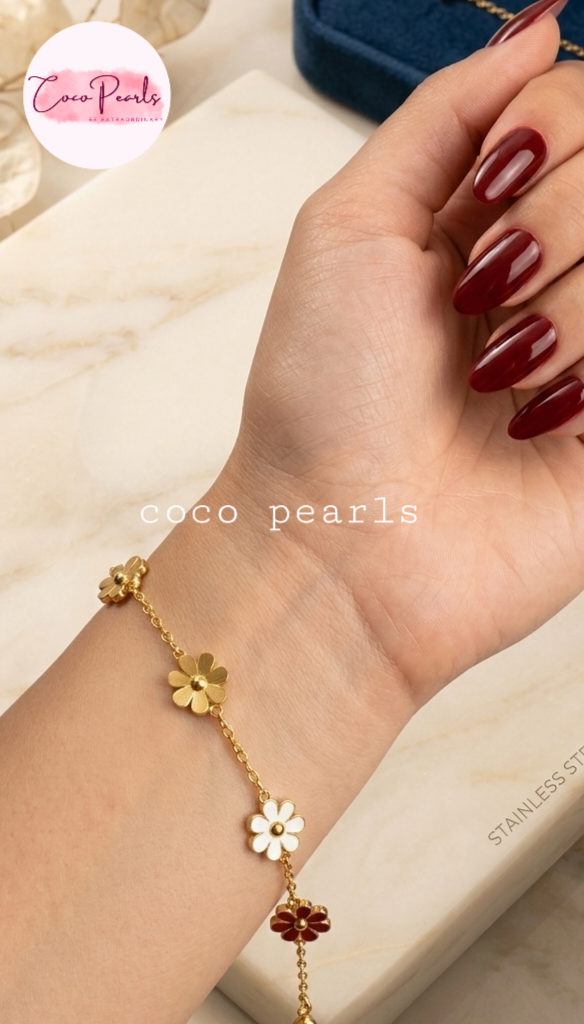 Coco pearls stainless steel anti tarnish Gold flower bracelet on a wrist with a blurred background