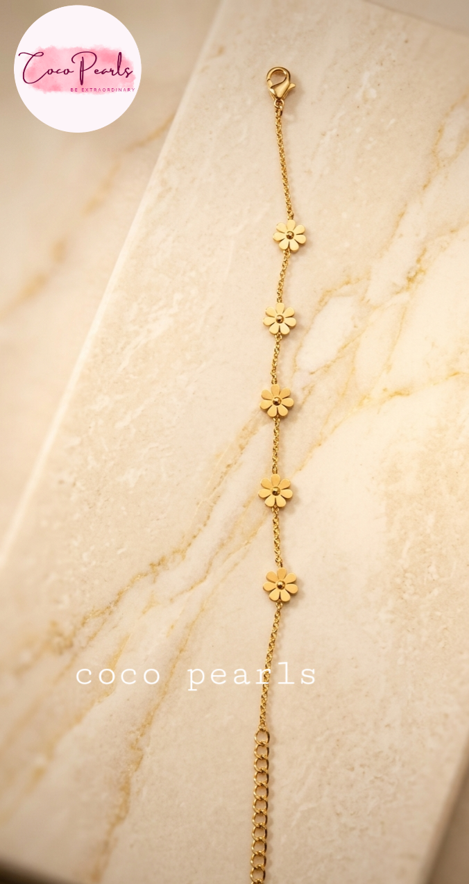 Coco Pearls Stainless steel anti tarnish Gold necklace with golden flower pendants on marble background.