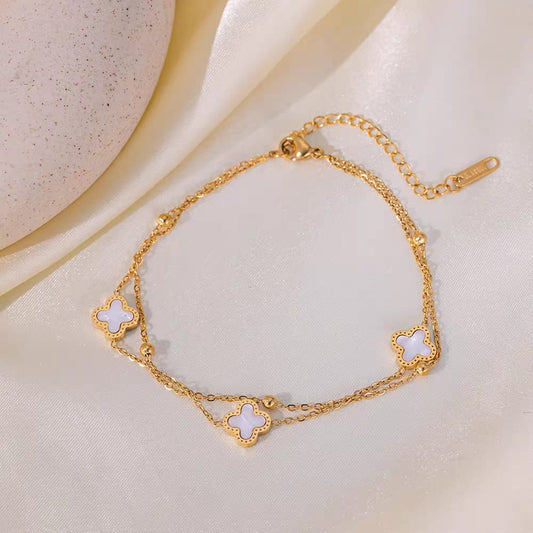 Coco Peals Stainless Steel anti  tarnish Gold 3 clover double chain bracelet with white clover charms on a light background