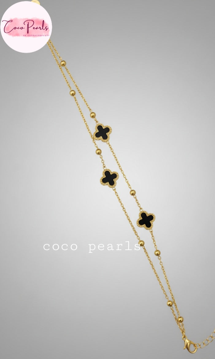 Coco Peals Stainless Steel anti  tarnish Gold 3 clover double chain bracelet with white clover charms on hand on a light background