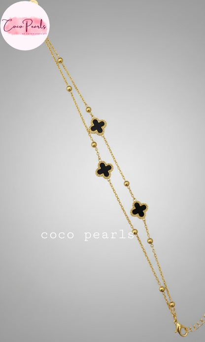 Coco Peals Stainless Steel anti  tarnish Gold 3 clover double chain bracelet with white clover charms on hand on a light background