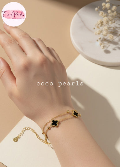 Coco Peals Stainless Steel anti  tarnish Gold 3 clover double chain bracelet with white clover charms on hand on a light background