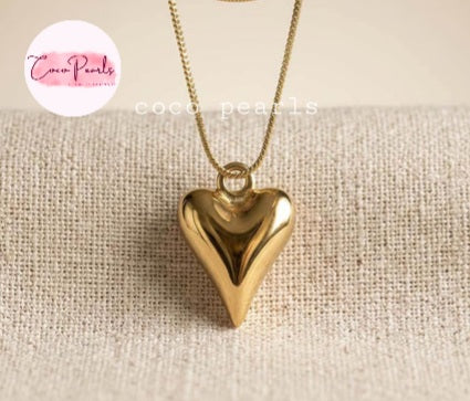 Coco pearls stainless Steel anti tarnish heart pendant necklace displayed on simple background 