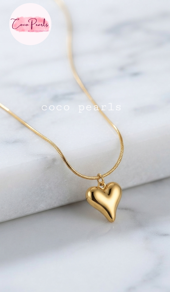 Coco pearls stainless Steel anti tarnish gold heart necklace displayed on simple background 