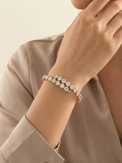 Coco pearls stainless Steel anti tarnish Gold bracelet with clear stones on a wrist against a neutral background