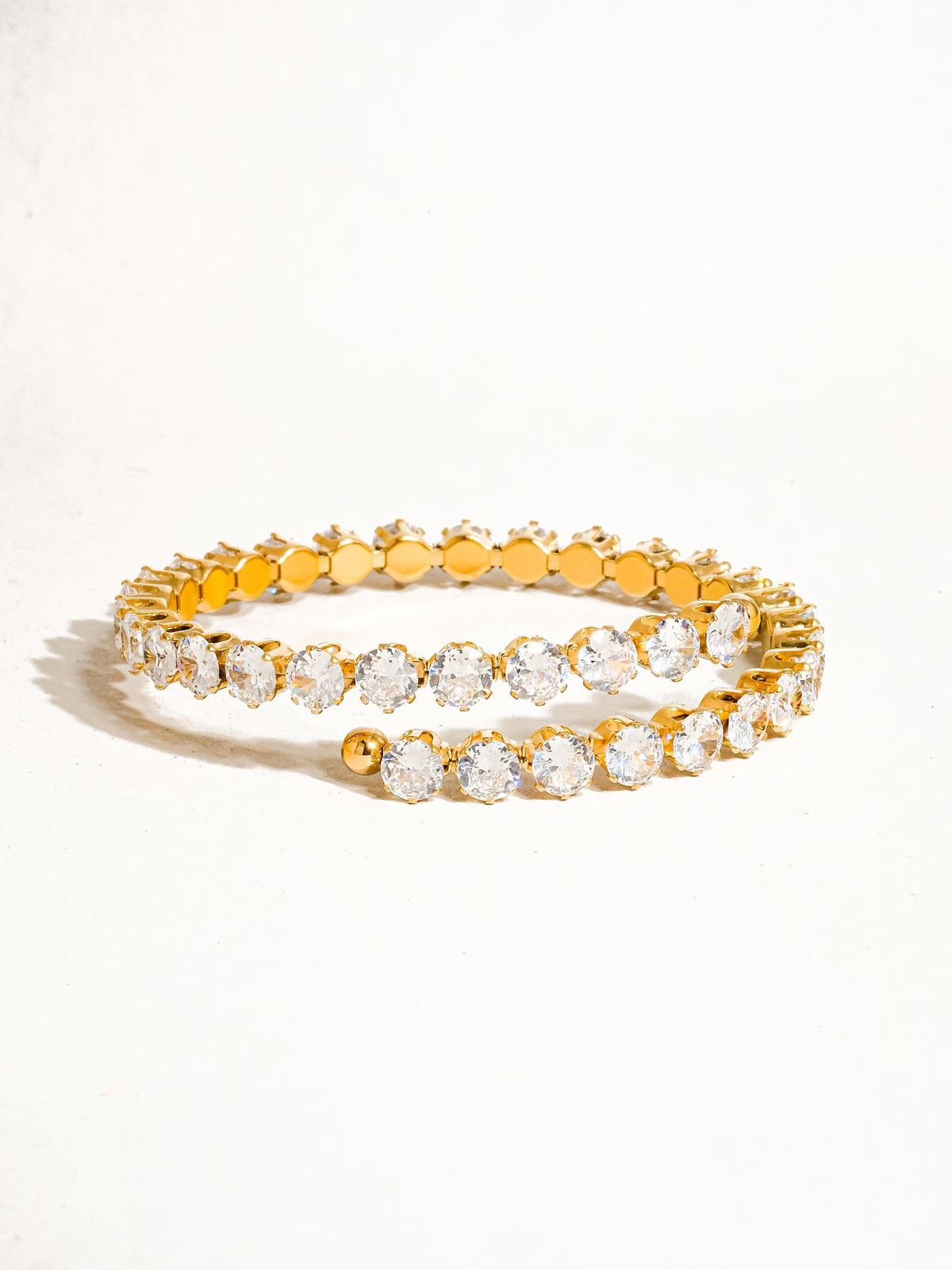 Coco pearls stainless Steel anti tarnish Gold bracelet with clear stones on a white background