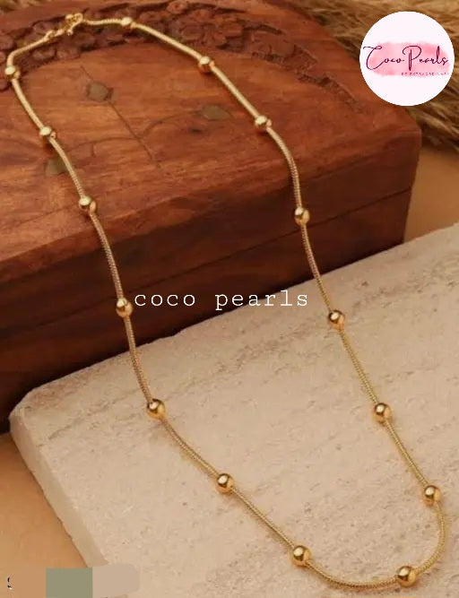 Coco pearls stainless Steel anti tarnish gold gold chian with balls displayed on simple background 