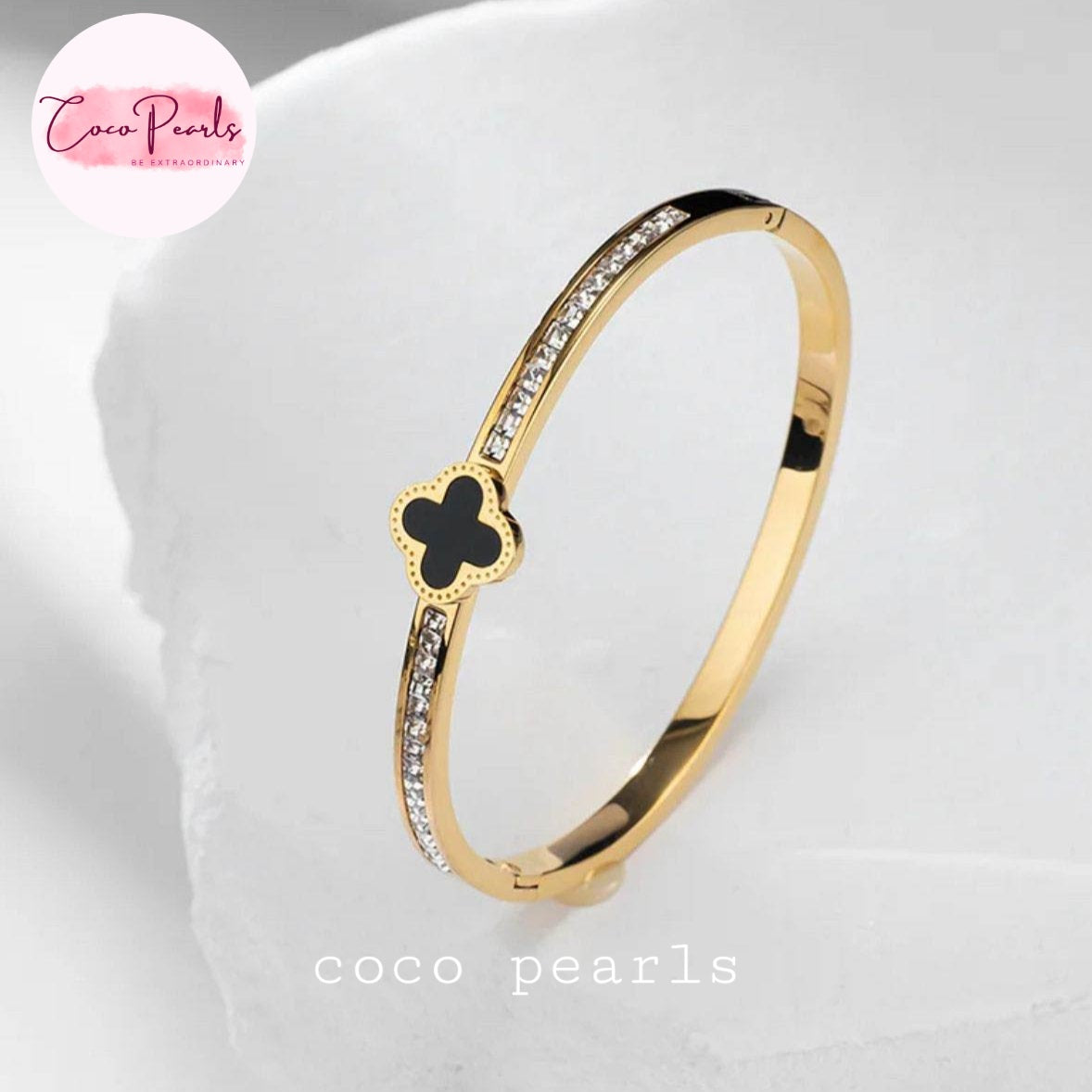 Coco pearls stainless Steel anti tarnish black clover diamond studded displayed on simple background 