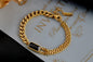 Coco Pearls Stainless Steel Anti Tarnish Gold black chain bracelet with a black gemstone on a decorative paper background