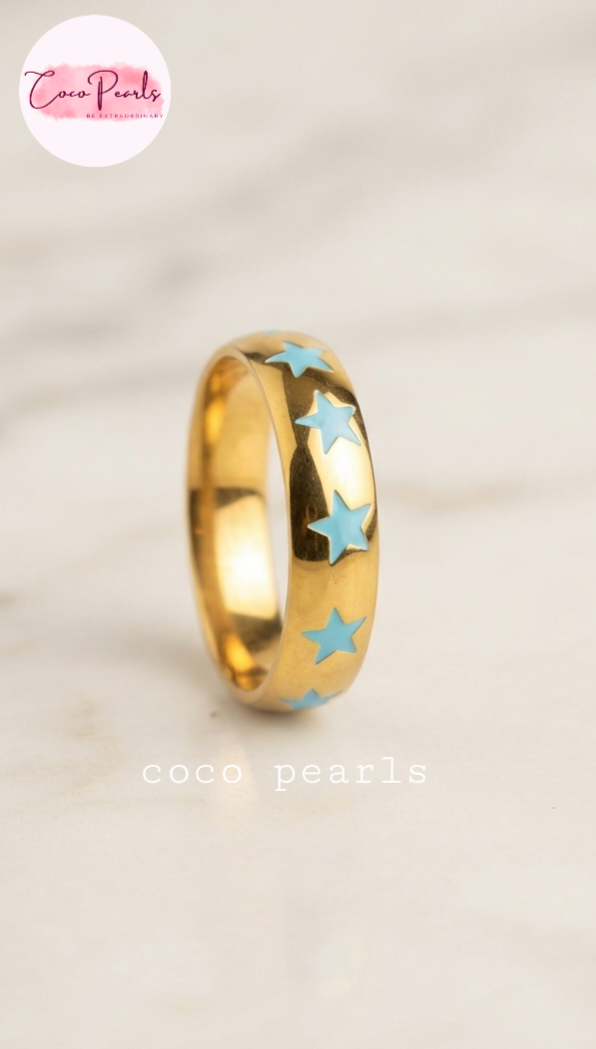 Coco pearls stainless Steel anti tarnish gold blue star rings displayed on simple background 