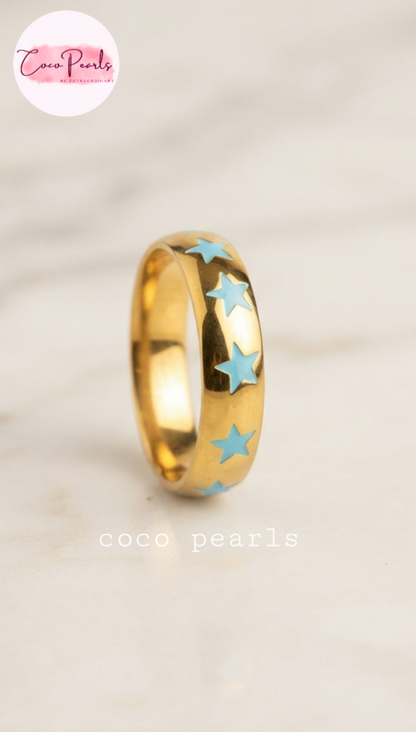 Coco pearls stainless Steel anti tarnish gold blue star rings displayed on simple background 