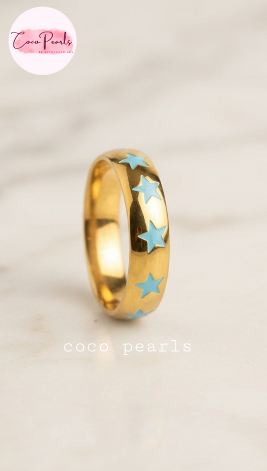 Coco pearls stainless Steel anti tarnish gold blue star rings displayed on simple background 