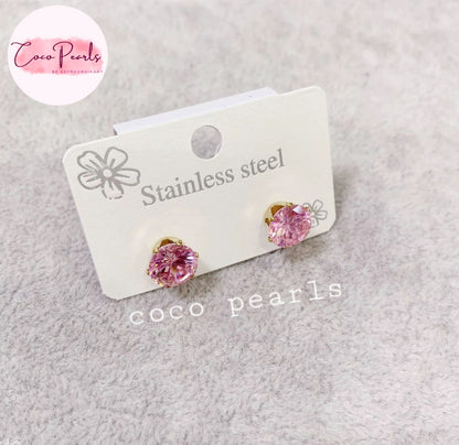 Coco pearls stainless Steel anti tarnish pair of pink pearl stud earrings in stainless steel settings, displayed on a white card