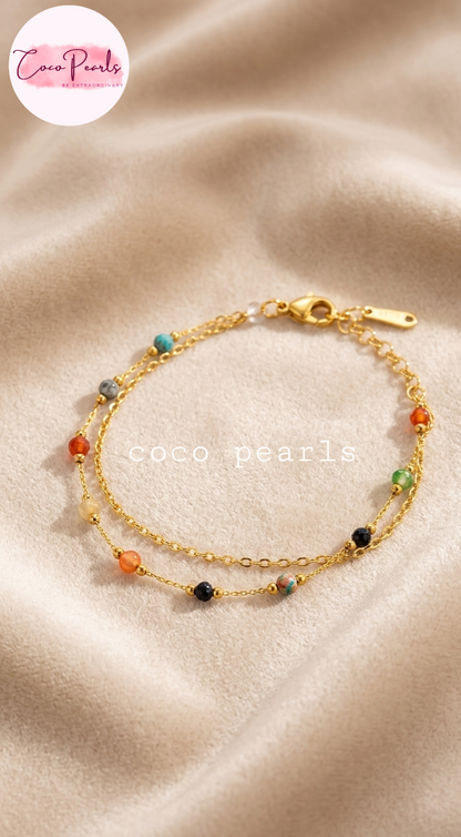 Coco pearls stainless Steel anti tarnish gold  boho gemstone bracelet with colorful beads displayed on beige background 