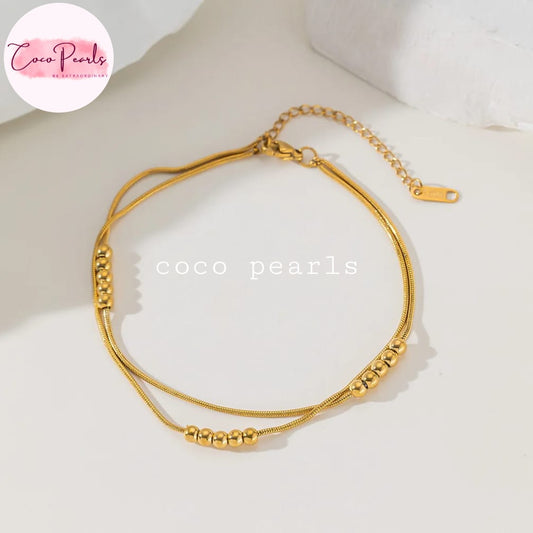 Coco pearls stainless Steel anti tarnish gold-toned double-strand snake chain anklet with small bead accents, displayed on a clean white surface