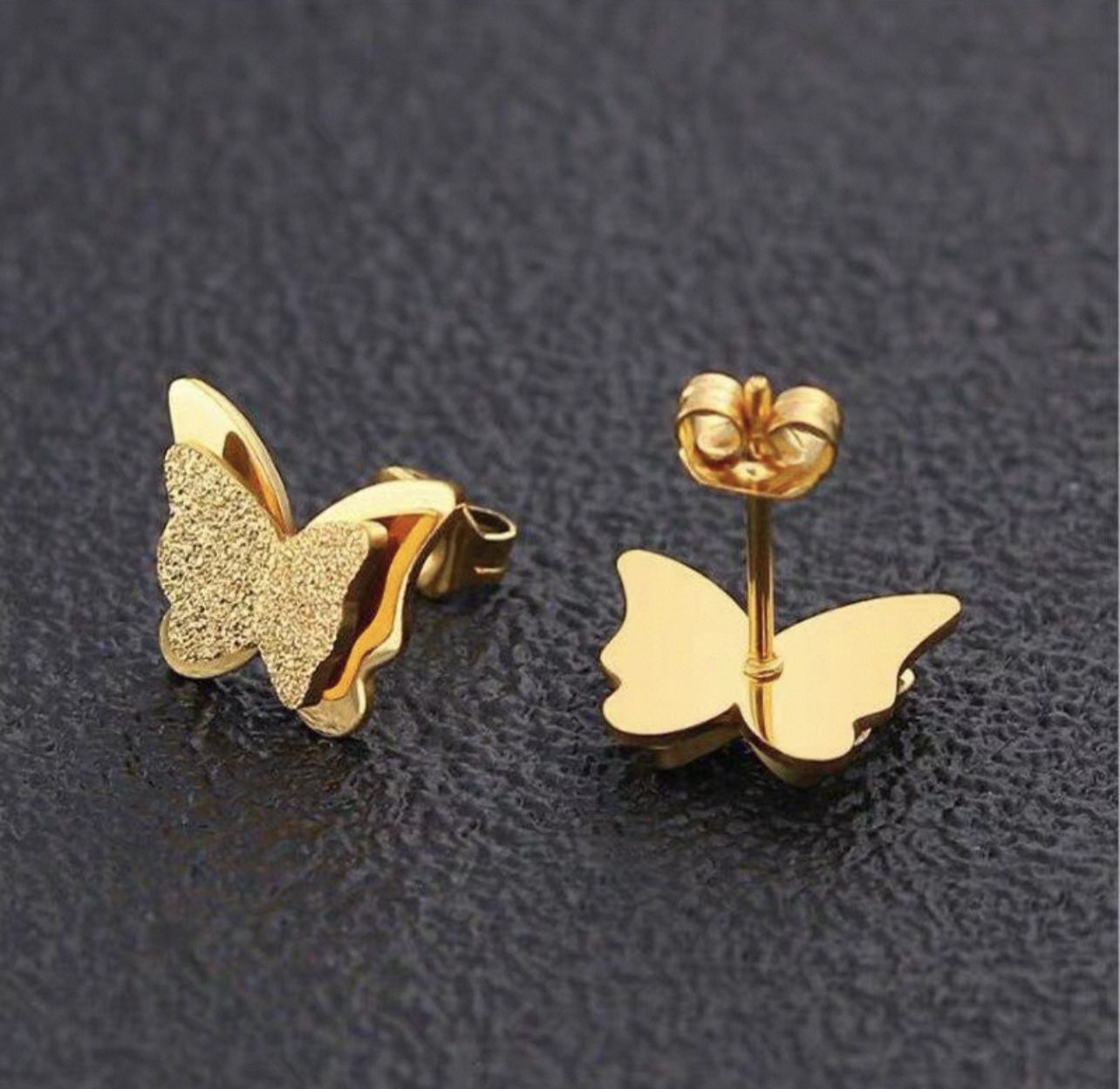 Coco pearls stainless Steel anti tarnish gold butterfly studs displayed on dark background 