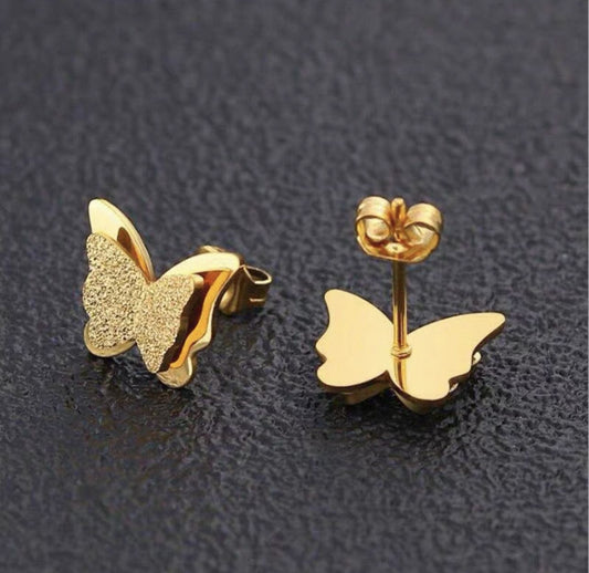 Coco pearls stainless Steel anti tarnish gold butterfly studs displayed on dark background 