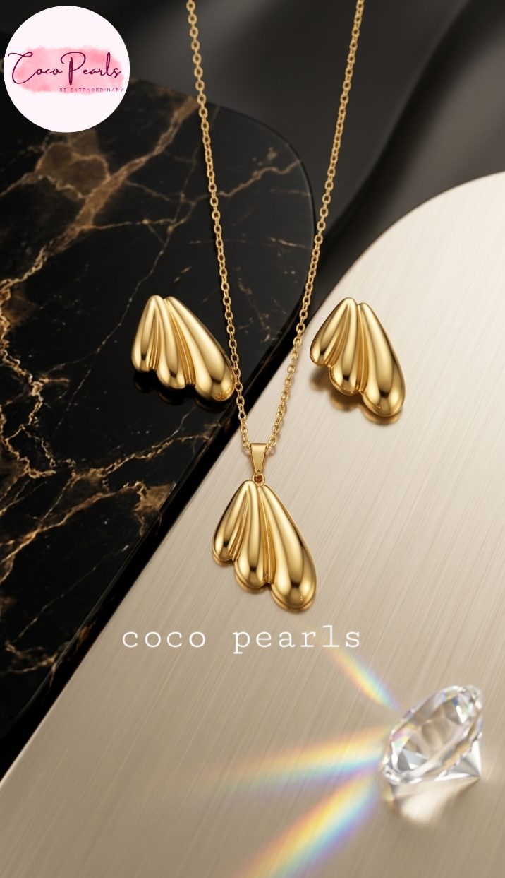 Coco pearls stainless Steel anti tarnish Gold butterfky wing jewelry set with necklace and earrings on a marble surface