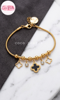 Coco pearls stainless Steel anti tarnish gold charms of luck bracelet displayed on simple 